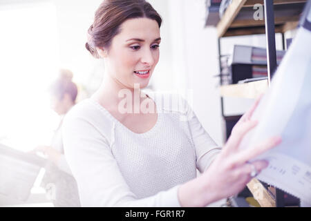 Interior designer browsing fabric swatches Stock Photo