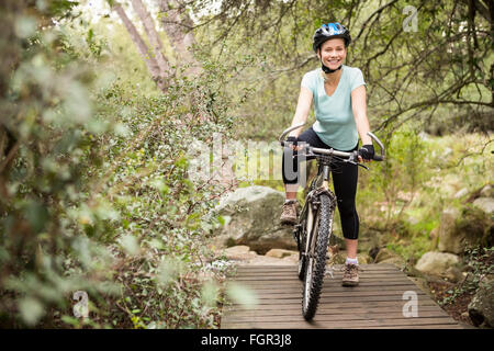 Smiling fit woman taking a break on her bike Stock Photo