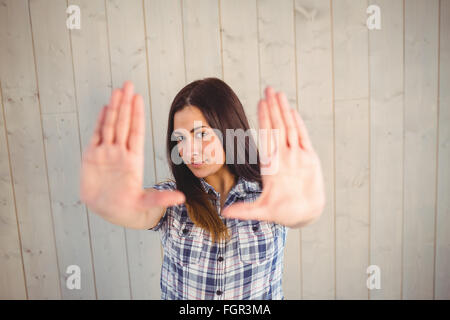 Pretty hipster holding hands up Stock Photo