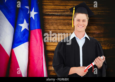 Composite image of man smiling as he has just graduated with his degree Stock Photo