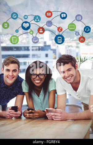 Composite image of creative team all using smartphones Stock Photo