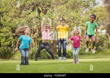 Happy classmates jumping in the air Stock Photo