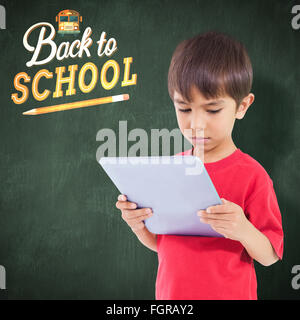 Composite image of cute boy using tablet Stock Photo