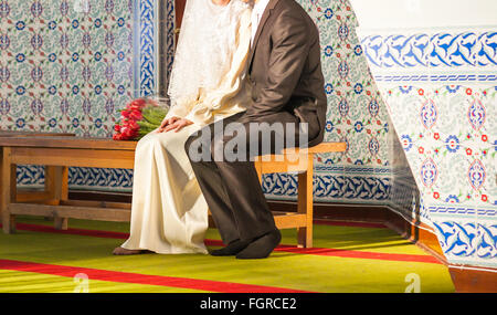 Happy islamic couple posing in front of mosque Stock Photo