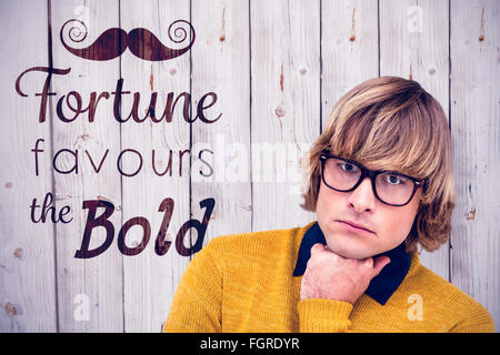 Composite image of portrait of thoughtful hipster businessman with hand on chin Stock Photo