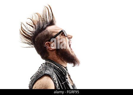 Profile shot of an angry young punk rocker with a Mohawk hairstyle screaming isolated on white background Stock Photo