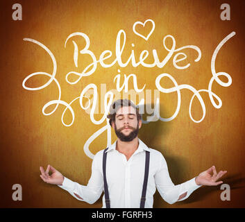 Composite image of hipster meditating arms outstretched Stock Photo