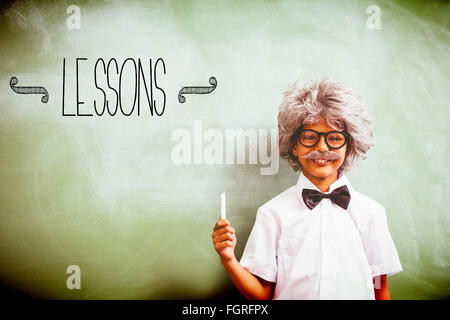 Lessons against boy dressed as senior teacher in front of blackboard Stock Photo