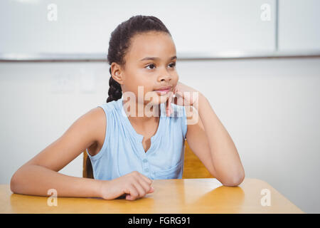 Happy student sitting at a desk Stock Photo