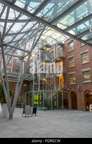 The atrium in the refurbished Royal Mills complex, Redhill Street, New Islington, Ancoats, Manchester, UK Stock Photo