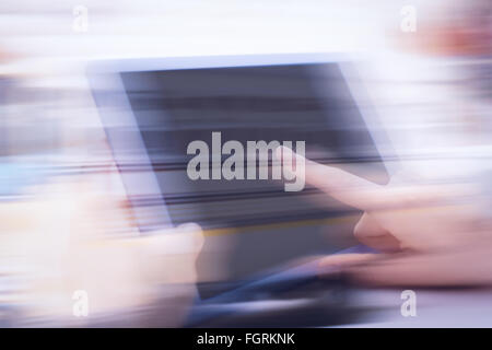 Composite image of cropped image of person using on digital tablet Stock Photo