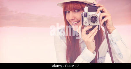 Composite image of attractive hipster photographing with camera Stock Photo