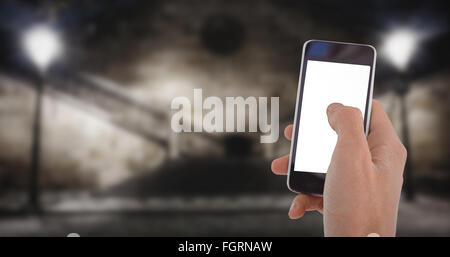 Composite image of cropped hand of man using mobile phone Stock Photo