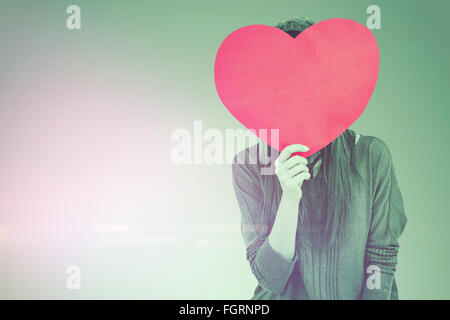 Composite image of hipster woman behind a red heart Stock Photo