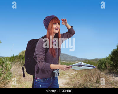 Composite image of smiling hipster woman with a map Stock Photo