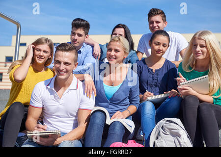 students outside sitting on steps Stock Photo