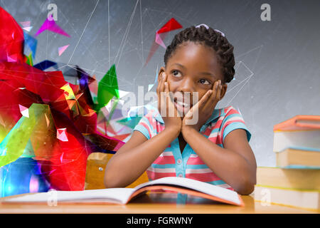 Composite image of pupil sitting at her desk Stock Photo