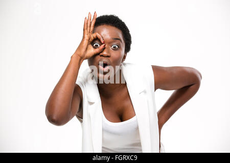 Amazed pretty african american young woman making funny face with hand over white background Stock Photo