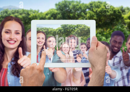 Composite image of hand holding tablet pc Stock Photo