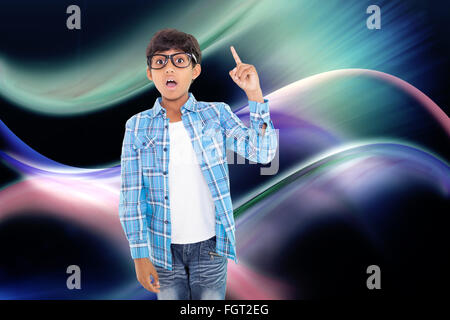 Composite image of cute boy pointing up with finger Stock Photo