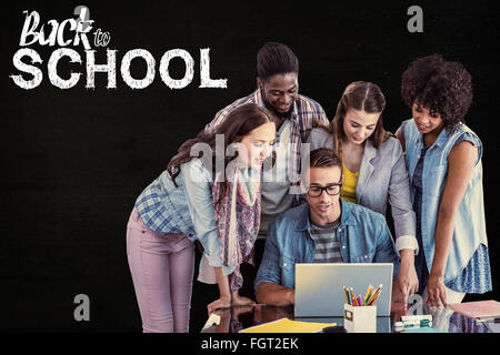 Composite image of fashion students working as a team Stock Photo