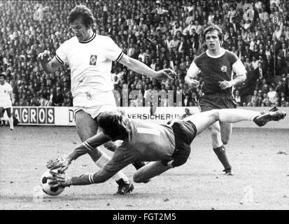 sports,football,games,Germany,national league,season 1970 / 1971,33rd match day,game Borussia Moenchengladbach versus Rot-Weiss Essen(4: 3),Boekelbergstadion,Moenchengladbach,29.5.1971,goal keeper Heinz Blasey(Essen)repelles the attack of striker Jupp Heynckes,behind defender Roland Peitsch,Rot Weiss,football match,soccer match,football matches,footballer,footballers,kicker,football player,football players,action,act,actions,acts,assaults,assault,attack,offensive move,attacks,offensive moves,defences,defenses,defense,defenc,Additional-Rights-Clearences-Not Available Stock Photo