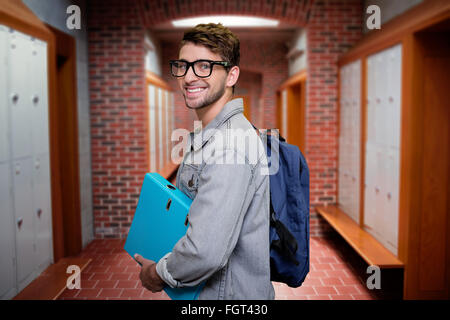 Composite image of student smiling at camera in library Stock Photo