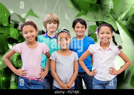 Composite image of cute pupils smiling at camera in classroom Stock Photo