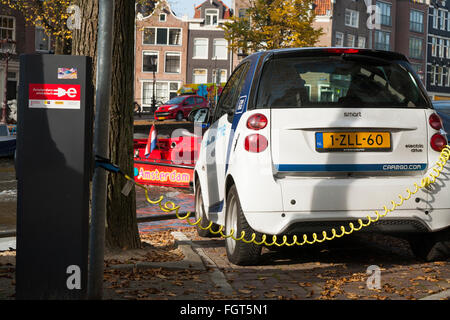 EV / Electric car / electrically powered cars being charged / having battery / batteries recharged at street / road charging terminal Stock Photo