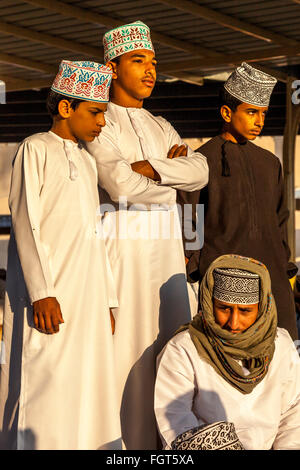 Young Omani Men At The Friday Livestock Market, Nizwa, Ad Dakhiliyah Region, Oman Stock Photo