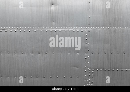 Abstract metallic background. Silver metal texture with rivets. Stock Photo