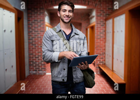 Composite image of student using tablet in library Stock Photo
