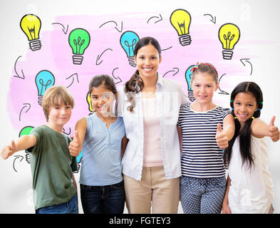 Composite image of cute pupils and teacher smiling at camera in computer class Stock Photo
