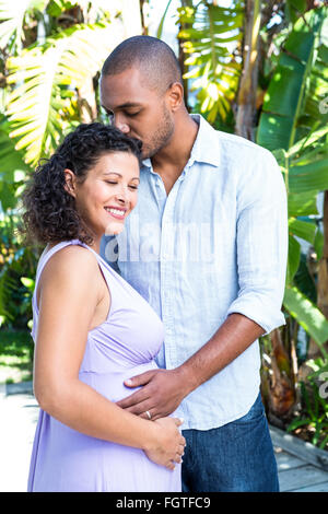 Husband kissing pregnant wife head Stock Photo