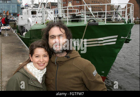 Rostock, Germany. 22nd Feb, 2016. Michael Buschheuer (R), founder of the refugee initiative 'Sea Eye, ' poses with his partner Hannelore Korduan in front of a cutter of the initiative, in Rostock, Germany, 22 February 2016. After its christening, the cutter is to head to the Mediterranean Sea to rescue refugees in distress. Credit:  dpa picture alliance/Alamy Live News Stock Photo