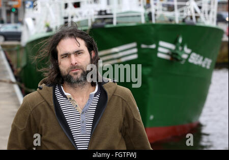 Rostock, Germany. 22nd Feb, 2016. Michael Buschheuer, founder of the refugee initiative 'Sea Eye, ' poses in front of a cutter of the initiative, in Rostock, Germany, 22 February 2016. After its christening, the cutter is to head to the Mediterranean Sea to rescue refugees in distress. Credit:  dpa picture alliance/Alamy Live News Stock Photo