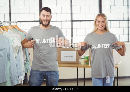 Portrait of volunteers showing volunteer text on tshirts Stock Photo