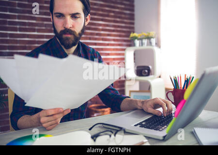 Confident creative businessman reading documents Stock Photo
