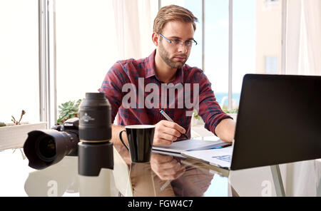 Amateur photographer working from his home studio Stock Photo