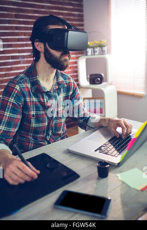 Focused creative businessman using 3D video glasses and laptop Stock Photo