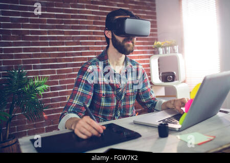 Serious creative businessman using 3D video glasses and laptop Stock Photo