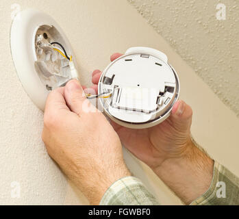 Removing Smoke Detector to Change the Battery Stock Photo