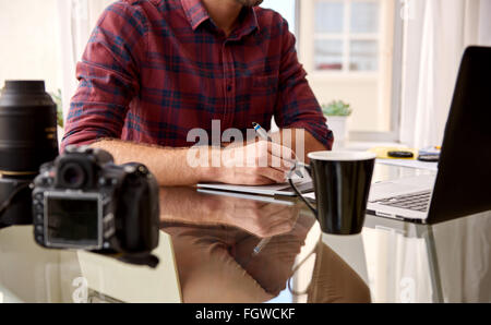 Headless crop of a photographer at his home workspace Stock Photo