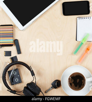 Flat lay office tools and supplies, tablet computer,cards, coffee and other stuff. Flat design and top view on desk as frame wit Stock Photo
