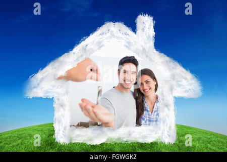 Composite image of happy man being given a house key Stock Photo