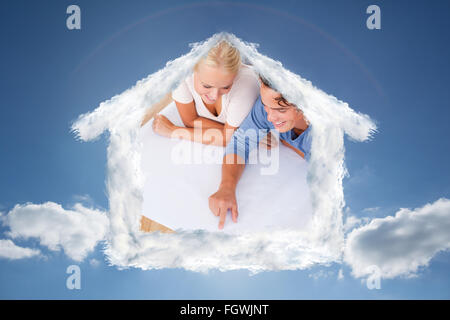 Composite image of young man showing a point on a plan to his fiance Stock Photo