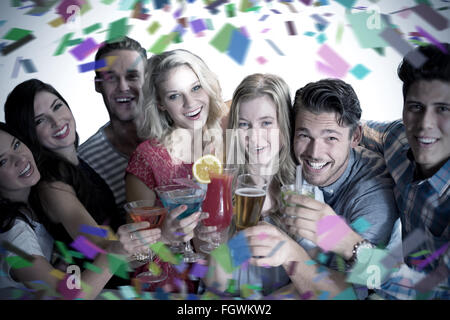 Composite image of friends drinking cocktails Stock Photo