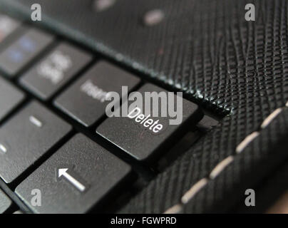 part of black keyboard laptop computer with focus on the delete button Stock Photo