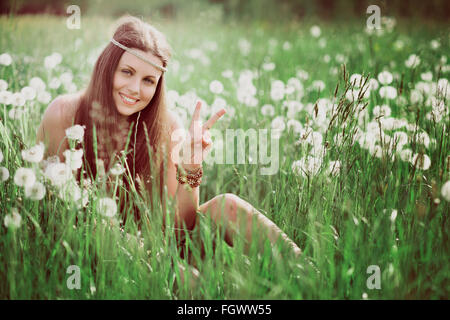 Peace sign from smiling free hippie . Nature and harmony Stock Photo