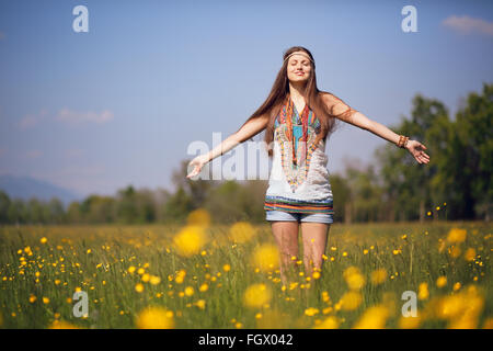 Free and smiling hippie in summer meadow. Vintage photo effect Stock Photo